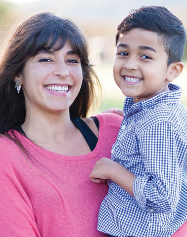 young Hispanic mother and son smiling