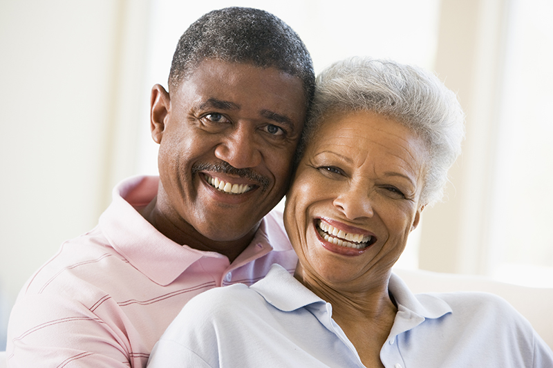 african canadian senior couple embraced and smiling